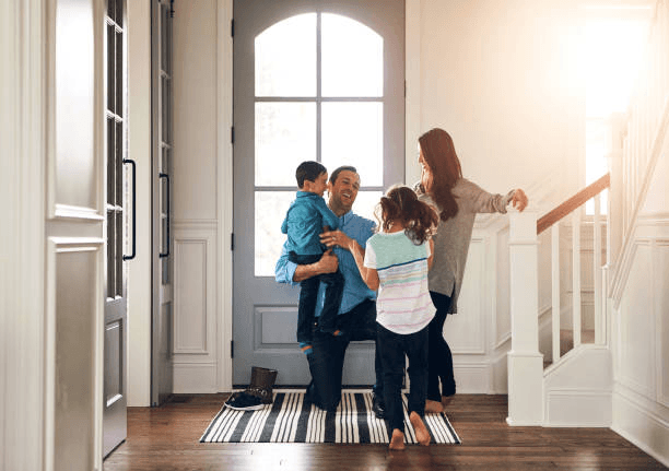 Parent greeting a trusted sitter at the door